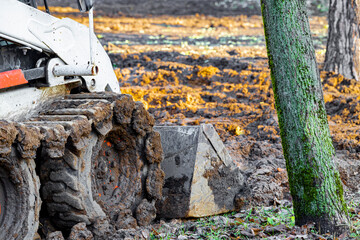 tractor tracks in the mud during work, dirty tractor close up