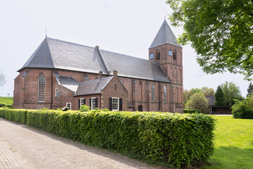 Fototapeta na wymiar Reformed church from the 14th century in the Dutch village of IJzendoorn in Gelderland.