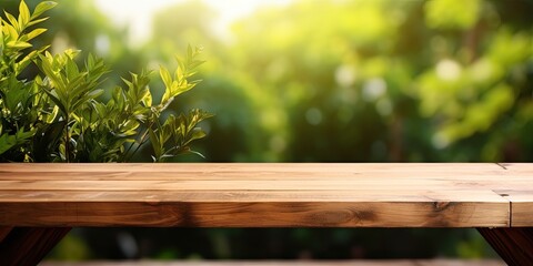 Wooden table over garden background for product presentation.