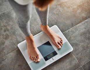 Top view crop faceless barefoot female standing at morning on digital weight and body fat scales with display - obrazy, fototapety, plakaty