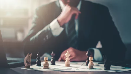 Fotobehang business, management, planning, strategy, chart, plan, leader, manager, chess, professional. businessman moving chess piece on chess board game and consider to move set in next turn for win. © Day Of Victory Stu.