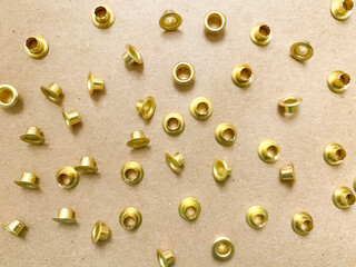 gold eyelets on a kraft paper background.