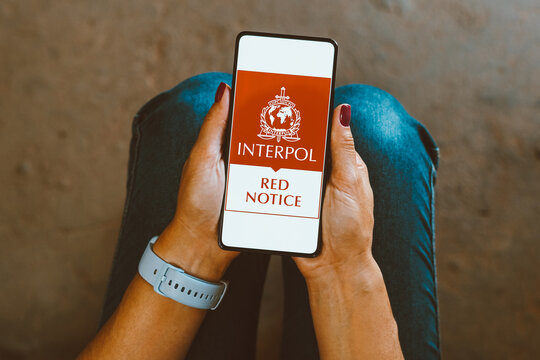 January 25, 2024, Brazil. In this photo illustration, the Interpol Red Notice logo is displayed on a smartphone screen.