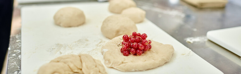 object photo of undercooked biscuits with fresh delicious red currant on it, confectionery, banner