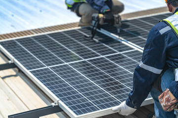 Worker Technicians are working to construct solar panels system on roof with sky and clound on background. Installing solar photovoltaic panel system. Renewable clean energy technology concept.