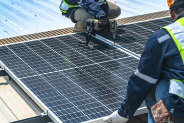 Worker Technicians are working to construct solar panels system on roof with sky and clound on...