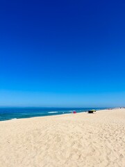 Blue seascape, sandy sea coastline, empty wild beach, pure blue sky, sea horizon