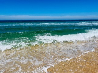 Blue seascape, sandy sea coastline, empty wild beach, pure blue sky, sea horizon