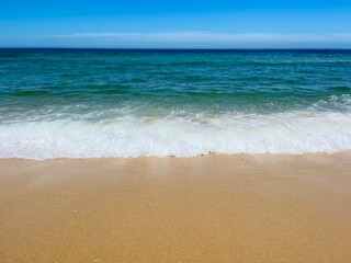 Fototapeta na wymiar Blue seascape, sandy sea coastline, empty wild beach, pure blue sky, sea horizon