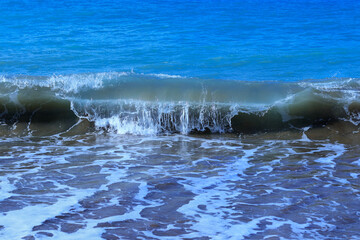 Obraz premium Sea waves. Seascape. Turbulent the sea. Vacation and summer concept. Powerful Ocean blue waves with white foam. Sea wave. Tourism. Travel. Marine nature. Large turquoise sea wave. Beautiful foam waves