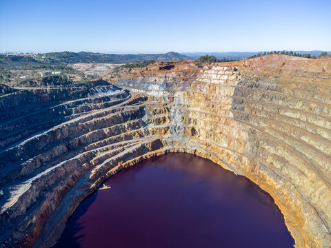 Aerial drone view of Corta Atalaya with mining levels at open mine pit. Deep excavation of pyrite and extraction of minerals of copper and gold in Minas de Riotinto, Huelva, Andalusia, Spain