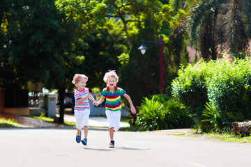 Kids running. Children run on city street.
