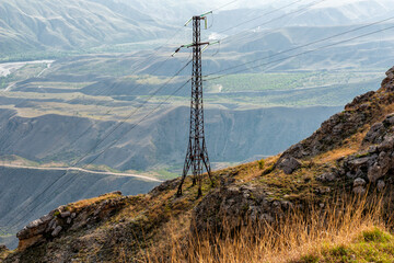Mountain landscape with high voltage power line mast
