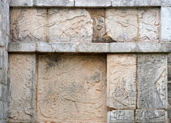 Tulum, Quintana Roo, Mexico - December 15, 2023: Detail of the engravings of the platform of the eagles and jaguars at Chichen Itza.