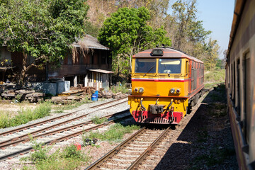 The diesel electric locomotive is parked at a small train station.
