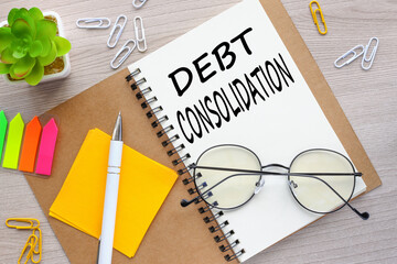 debt consolidation, glasses lie on a notepad. text on the page. bright stickers