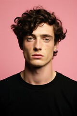 Fototapeta premium A man with curly hair is seen wearing a black shirt.