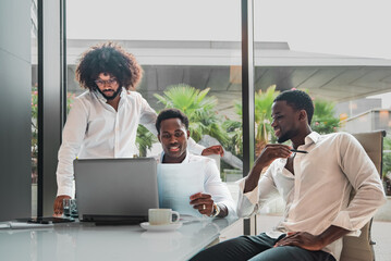 Team of Young African american Businessmen Working Together on a Project in a Bright modern Office...