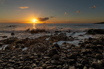 Wave at rocky shore of the Atlantic Ocean at high tide at sunset, La Palma, Canary Islands, Spain 