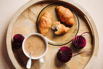 Cup of coffee and chocolate croissants.
