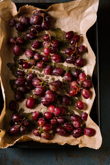 Red grapes with spices and olive oil on  parchment.