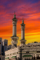 Fototapeta na wymiar The minarets of the Meccan Kaaba with amazing sunset. Mecca, Saudi Arabia