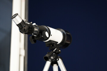 looking through a telescope. A white telescope to see the sky. Blue sky with stars star gazing, clear blue sky.             