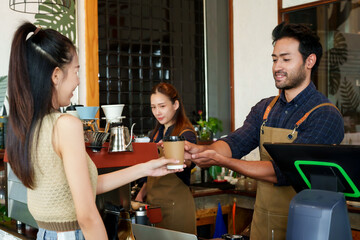 Couples, businessmen small cafes, men various nationalities. Serving take-out paper coffee cups female Asian customer cream-colored shirt. Meanwhile Asian girlfriend making orders coffee machine.