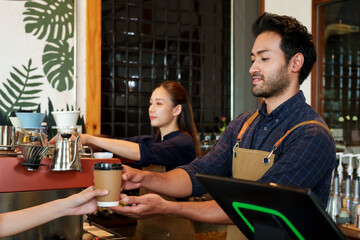 Couple, business people coffee shop and small business men various nationalities Serving disposable brown paper coffee cups Close hand Asian woman Meanwhile Asian girlfriend makes coffee coffee maker.