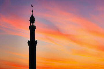 Mosque's minaret silhouetted against the colorful, Ramadan sunset, Evening sky, orange and pink