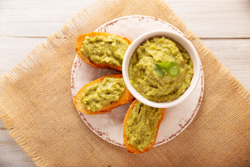 Smashed avocado toast breakfast. Mashed avocado toasts. Healthy eating, dieting, tasty vegan vegetarian food. Served on white plate. Easy recipe for healthy homemade breakfast.