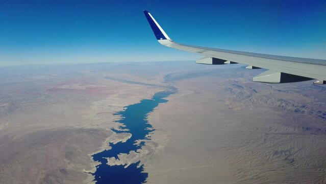 Plane window view flying over lake mead nevada arizona border desert usa deserted remote location
