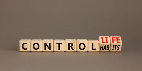 Control habits and life symbol. Concept words Control habits to Control life on beautiful wooden cubes. Beautiful grey table grey background, copy space. Business control habits and life concept.