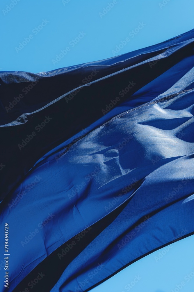 Poster a picture of a large blue flag flying in the air. suitable for various applications
