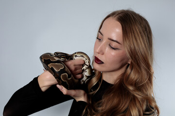 Snake python shooting on blond young woman with light effekts