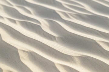 A desert landscape with textured dunes and wavy sand patterns, shaped by the wind