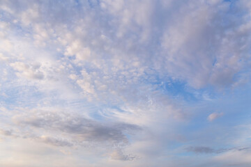 Beautiful epic soft gentle blue sky with white and grey cirrus and fluffy clouds background texture, heaven