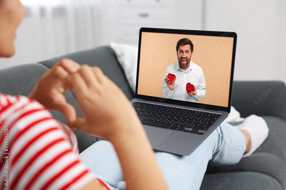 Poster Long distance love. Woman having video chat with her boyfriend via laptop at home, closeup