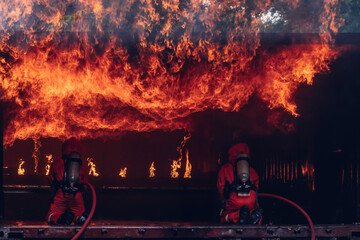 Firefighter Concept. Several firefighters go offensive for a fire attack. Fireman using water and...