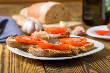 toast in olive oil spread with garlic and  tomato