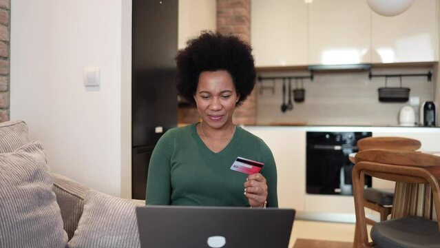 African woman shopping online at home
