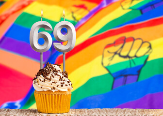 Birthday candle number 69 - Gay march flag background