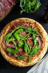 parma ham pizza with arugula, top view