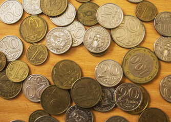 Tenge coins lie on the table, top view, Kazakhstani Tenge coins