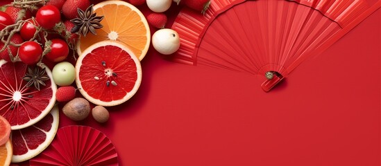 Flat lay oranges, money envelopes, festival paper fans and blossom flowers on red background.