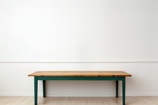 Empty wooden forest green table over white wall background