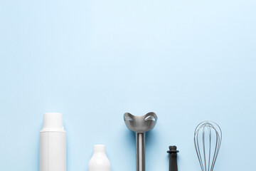 Electric hand blender on blue background. Top view. Space for text.