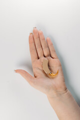 hearing aid on white background in hand, cochlear implant