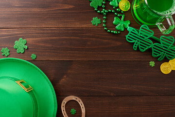 Majestic green celebration: St. Patrick's revelry. Top view photo of leprechaun hat, party glasses,...