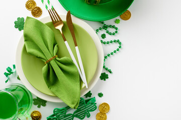 Table blessings: St. Patrick's Day festivity arrangements. Top view photo of plates, cutlery, pint...